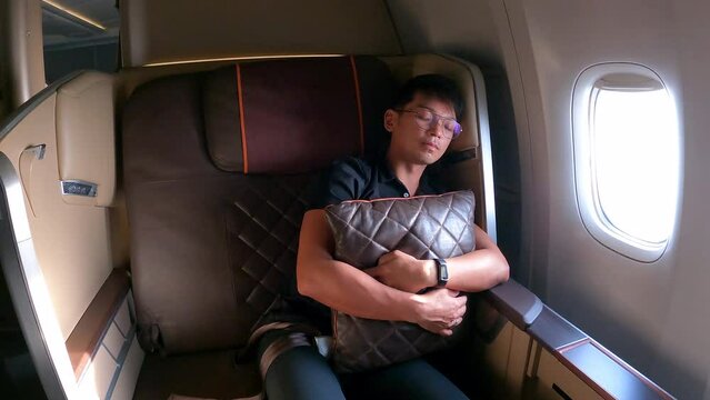 Man resting on first class seat