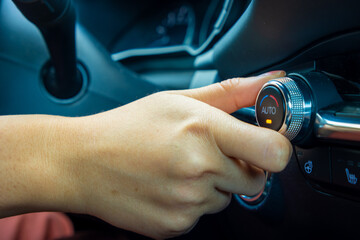 Driver adjusting car temperature knob
