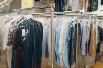 Dry cleaning clothes. Clean cloth chemical process. Laundry industrial dry-cleaning hanging clothes...