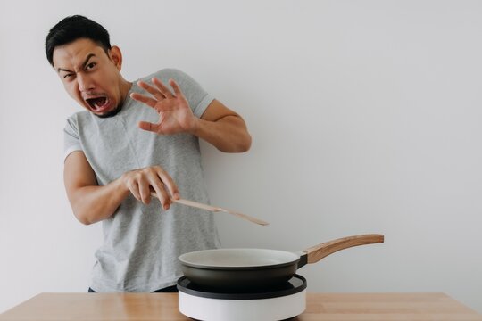 Funny Face Newbie Cooking Asian Man Afraid Fried Oil Isolated On Background.