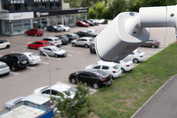 Video surveillance camera installed on a vehicle parking.