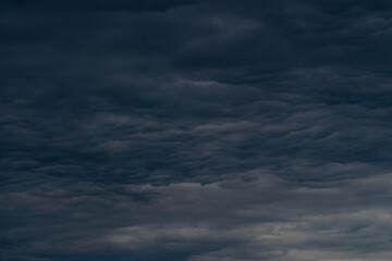 Fototapeta na wymiar Rain clouds background. The clouds turn dark gray, like big smoke before rain.