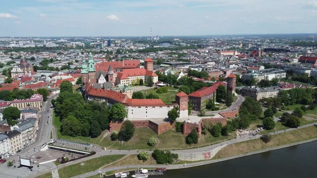 Flyover of the Wawel Royal Castle Cathedral on the Vistula (Wisła) River - Krakow, Poland, a Polish cultural capital, medieval and renaissance architecture, city center - 4K 30FPS Tracking Forward