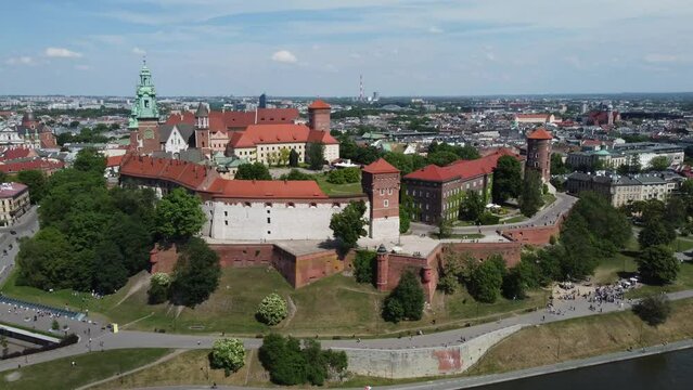 Flyover of the Wawel Royal Castle Cathedral on the Vistula (Wisła) River - Krakow, Poland, a Polish cultural capital, medieval and renaissance architecture, city center - 4K 30FPS Tracking Backward