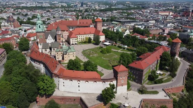 Flyover of the Wawel Royal Castle Cathedral on the Vistula (Wisła) River - Krakow, Poland, a Polish cultural capital, medieval and renaissance architecture, city center - 4K 30FPS Tracking Backward