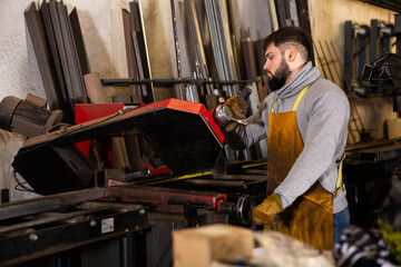 Portrait of professional man worker during work in workshop