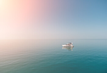 Aerial yacht on calm sea. Luxury cruise trip. View from above of white boat on deep blue water....