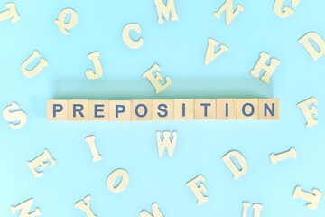 Preposition concept in English grammar and learning class lesson. Wooden blocks typography word...