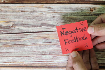 How to handle customer negative feedback concept. Hand holding red note with written word with copy...