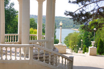 Moldova. Kishinev. 08.28.2022. Arbor with white columns and a view of the lake. Park Valea Morilor.