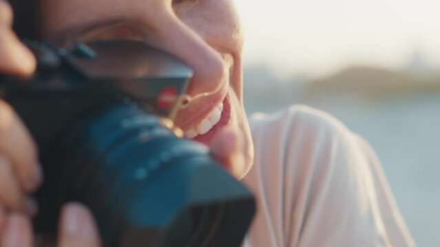 Lady photographer. Happy woman photographer takes pictures of someone with mirrorless camera outdoor