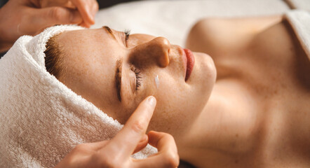 Woman patient receiving eyes massage, applying collagen under the eyes. Body care, spa. Health care...