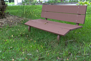 a brown plastic park bench