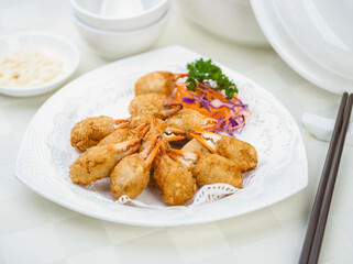 Deep fried breaded Crab Claws on white porcelain plate