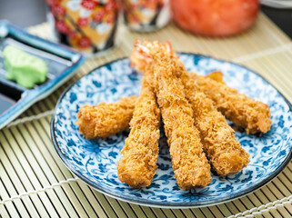 Japanese breaded deep fried prawns served on blue and white porcelain plate