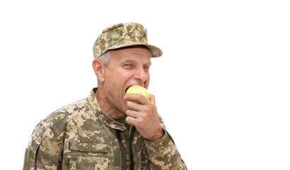 Soldier eat green apple and smiling to the camera. Portrait of old defender isolated on white...