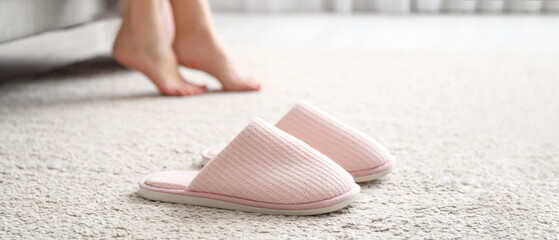 Soft comfortable slippers on carpet - obrazy, fototapety, plakaty