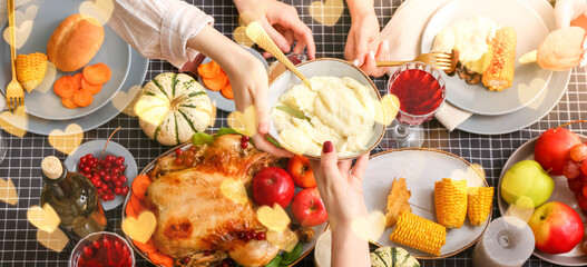 People having tasty Thanksgiving dinner at table, top view