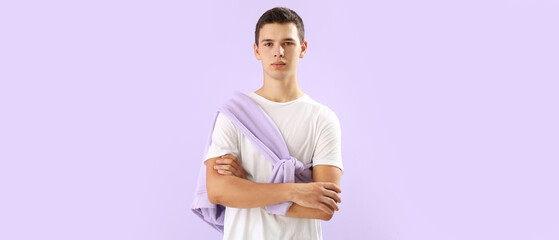 Teenage boy in t-shirt on lilac background