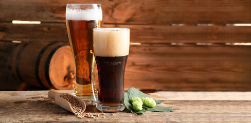 Glasses of fresh beer on wooden table