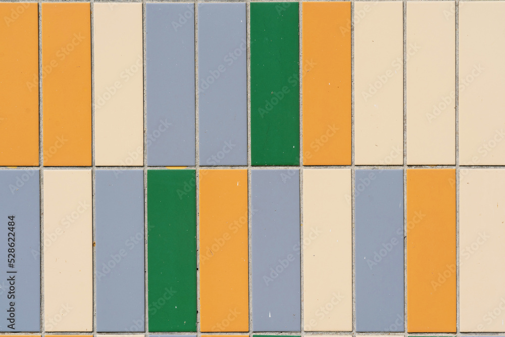 Wall mural Fragment of finishing the facade of the building with ceramic tiles of different colors. Close-up. Background. Texture. - Wall murals