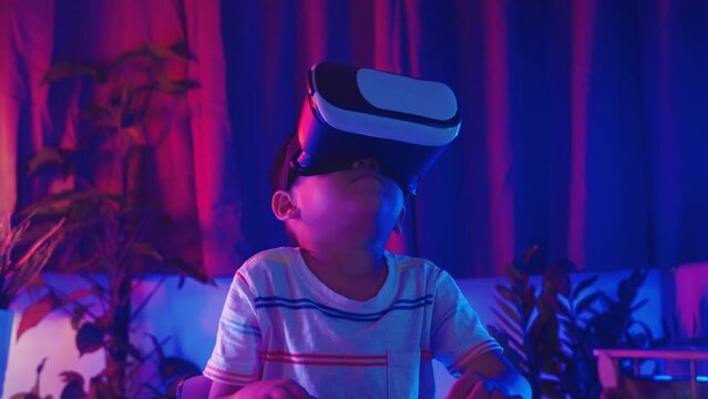 Little kid boy experiencing virtual reality goggles experiencing reality, Child wear VR helmet glasses surprised look left right and excited emotional purple and blue background, Virtual technology