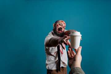 Creepy horror devil wanting cup of coffee, chasing after hand with carton cup with drink....