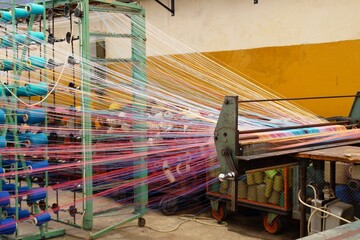 colored linen warp threads on a weaving machine