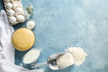 Set of ingredients for baking with raw dough on color background