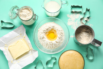Set of ingredients for baking and cutters on color background