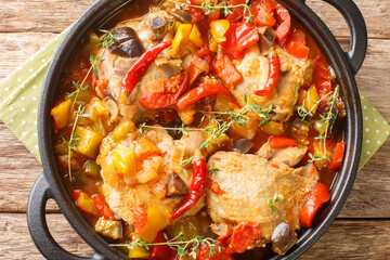 African Ivory Coast Style Kedjenou Chicken Stew with vegetables closeup in the pan on the table. Horizontal top view from above
