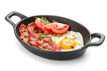 Frying pan with delicious fried egg, bacon and tomatoes on white background