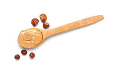 Wooden spoon with tasty hazelnut butter on white background