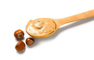 Wooden spoon with tasty hazelnut butter on white background, closeup