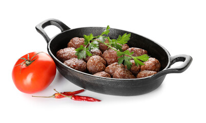 Baking dish with tasty meat balls, parsley, tomato and chili peppers on white background