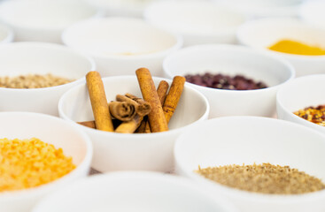 Cinnamon sticks in a bowl amongst spices