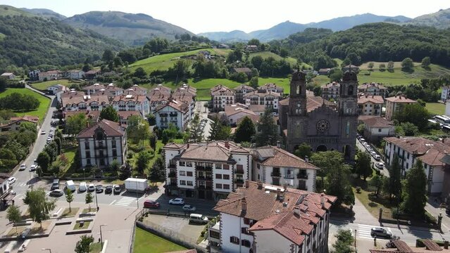Pan right shot of daylight traffic in a busy square of town Elizondo, capital of Baztan Valley.