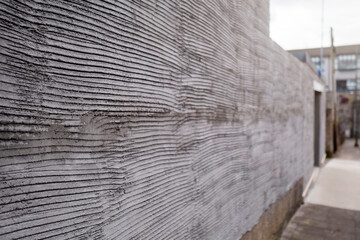 Freshly plastered wall of exterior of a house building and fence. Selective focus. Renovation and home repair.