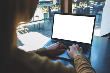 Mockup image of a woman using and typing on laptop computer with blank white desktop screen