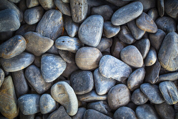 small smooth waterworn black pebbles or stones for use decor and garden landscaping. tone garden interiors. stone spa