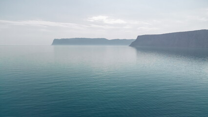 Aerial panoramic view of seascape with crystal clear azure sea and rocky shores. Yachts in a beautiful lagoon on backdrop of rocks. The concept of an ideal destination for summer travel and vacation.