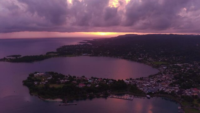 Aerial view of Sunrise over the East harbour in Port Antonio in Jamaica with pink and purple skies reflecting off the ocean