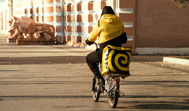 October 6, 2021, Moscow, Russia. An employee of the Yandex Food delivery service on a bicycle on one of the streets in the Russian capital.