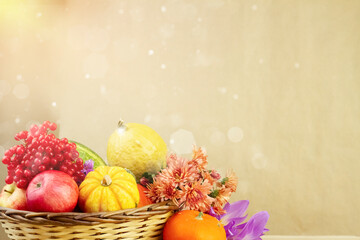 Harvest of autumn fruits and vegetables in a wicker basket 