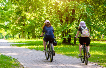 Cyclists ride on the bike path in the city Park
