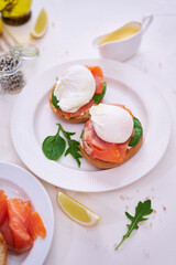 Cream cheese, Smoked salmon and poached egg toasts on a plate