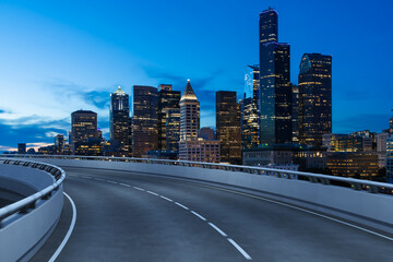 Naklejka premium Empty urban asphalt road exterior with city buildings background. New modern highway concrete construction. Concept way to success. Transportation logistic industry fast delivery. Seattle. USA.