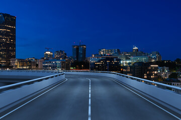 Obraz premium Empty urban asphalt road exterior with city buildings background. New modern highway concrete construction. Concept way to success. Transportation logistic industry fast delivery. Seattle. USA.