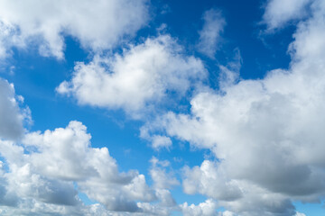 Clear blue sky and white clouds. Air clouds in the blue sky. Beautiful white cloud on clear blue sky as nature concept. Abstract style for text, design, pattern, background