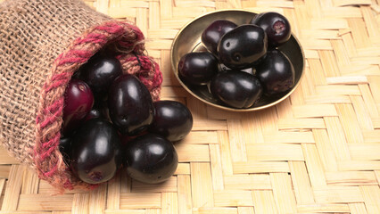 Jambul or Jamun (Syzygium cumini) isolated on wooden background